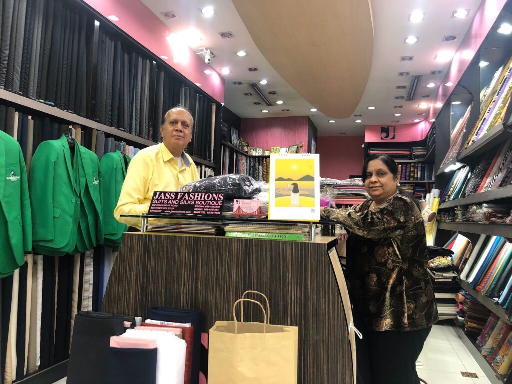Kenny and Poona, owners of Jass Fashions, at the shop counter